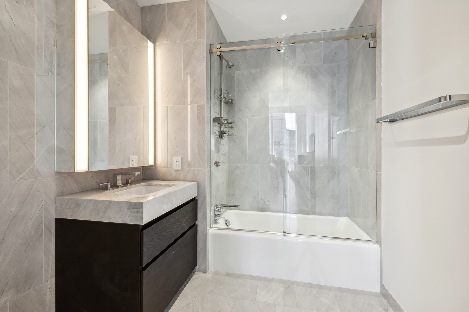 15 Hudson Yards, Unit 74F Manhattan, NY 10001 - Photo 9 of 13 a bathroom with a tub sink shower and two mirror