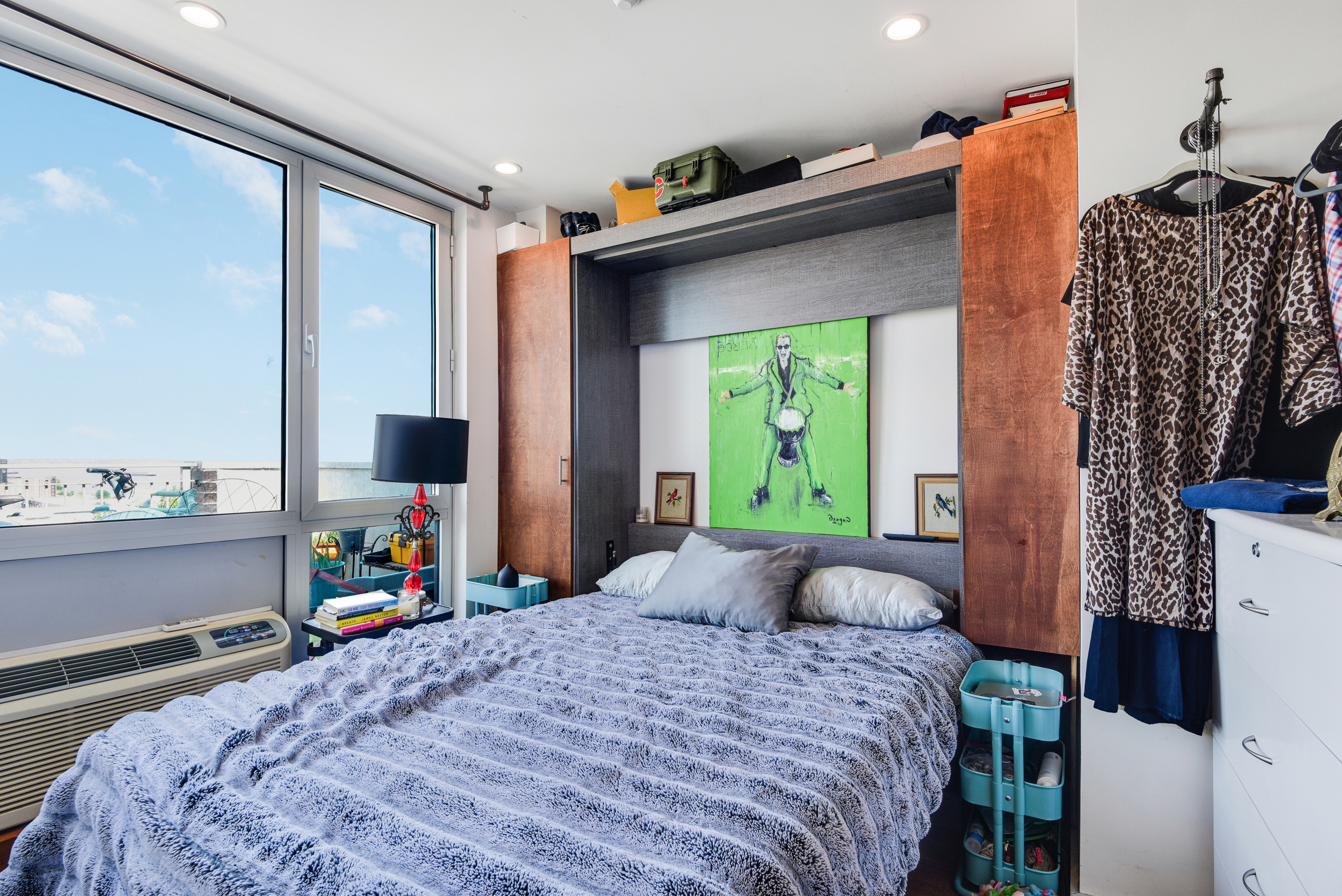 4907 4th Avenue, Unit 7A Brooklyn, NY 11220 - Photo 10 of 13 a bedroom with a bed and a flat tv screen on the dresser