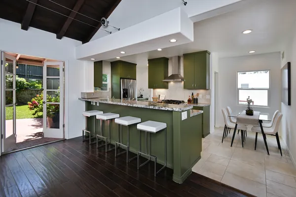a kitchen with stainless steel appliances granite countertop a sink stove and refrigerator