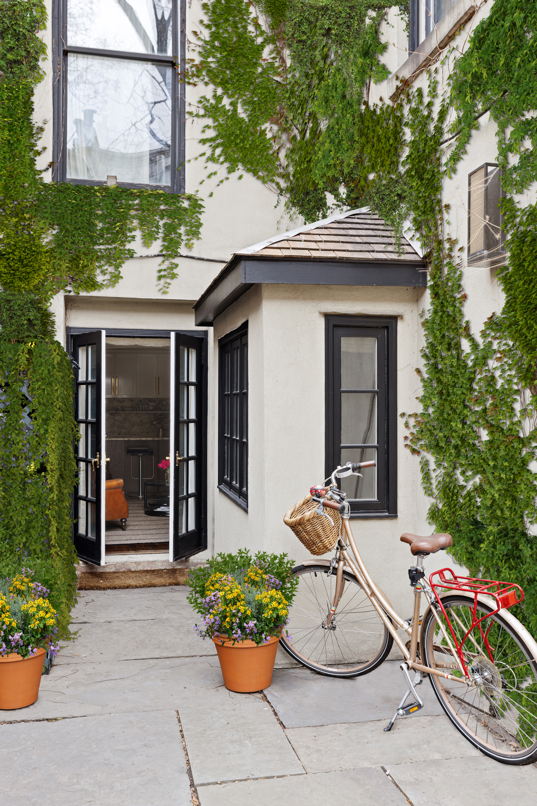 72 Perry Street, Unit GARDEN Manhattan, NY 10014 - Photo 12 of 15 a front view of a house with a yard and fountain