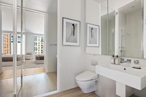 a bathroom with a toilet sink and shower