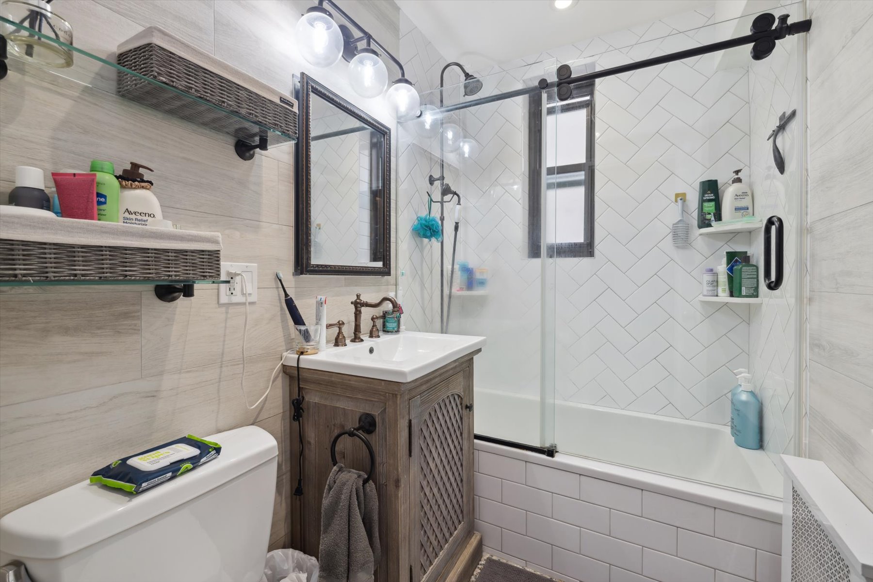 221 East 78th Street, Unit 4J Manhattan, NY 10075 - Photo 5 of 7 a bathroom with a sink a toilet and shower