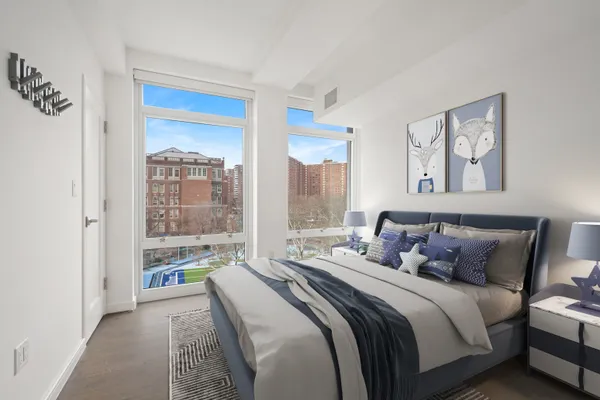 a bedroom with a large bed and a large window