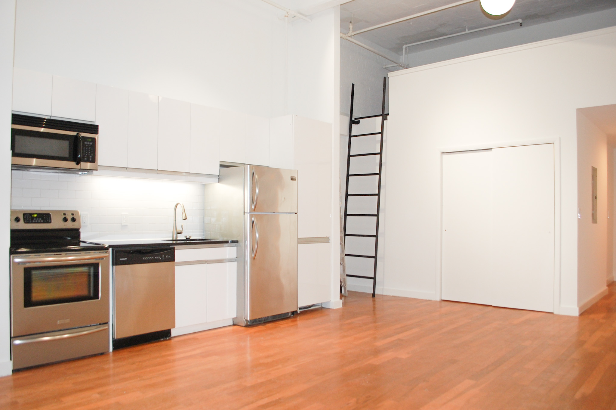 44 Berry Street, Unit 2G Brooklyn, NY 11249 - Photo 2 of 7 a kitchen with stainless steel appliances a refrigerator and a stove