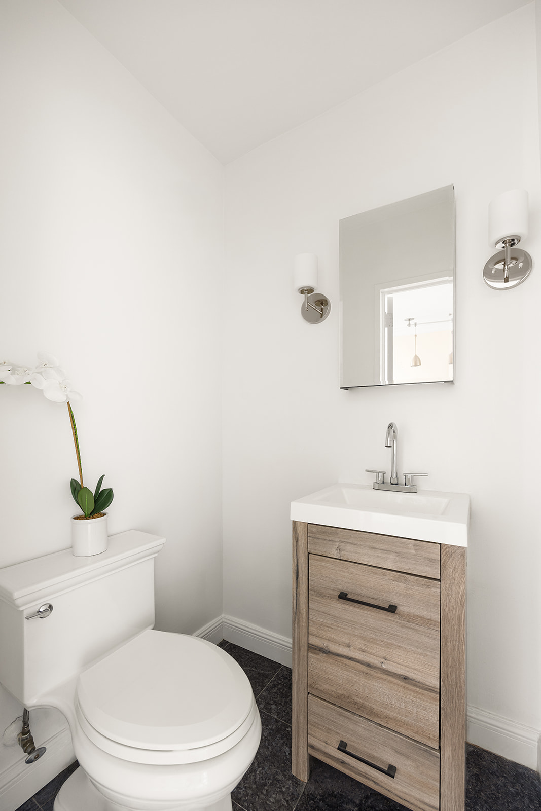 159 West 53rd Street, Unit 27H Manhattan, NY 10019 - Photo 10 of 15 a bathroom with a toilet a sink and mirror