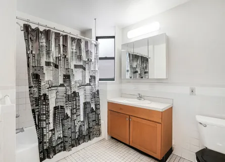 a bathroom with a double vanity sink toilet and shower