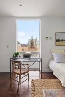 a living room with a table and a potted plant