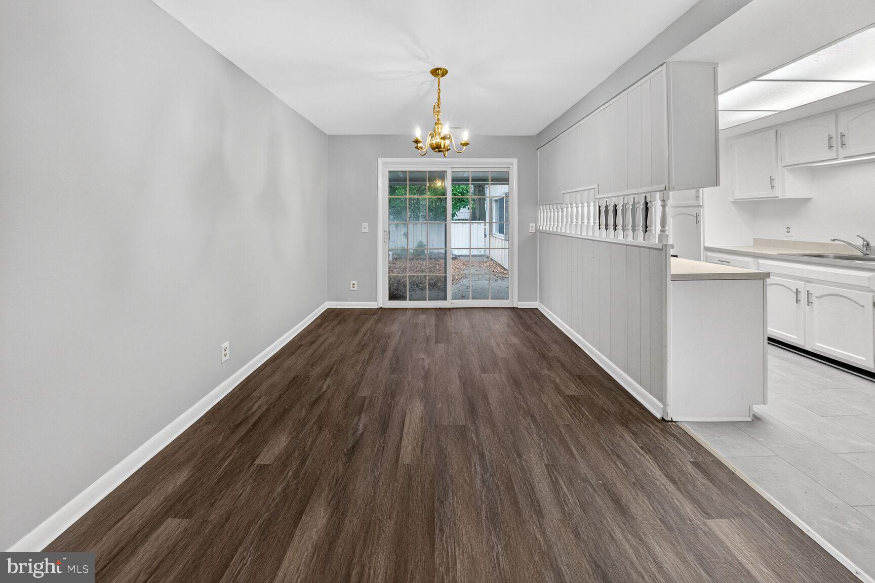 14603 Edelmar Drive, Unit 132A Silver Spring, MD 20906 - Photo 25 of 52 a hallway with wooden floors and chandelier