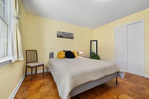 a bedroom with a bed and table chair