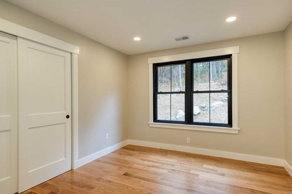 171 Randall Road Berlin, MA 01503 - Photo 29 of 41 an empty room with wooden floor and windows