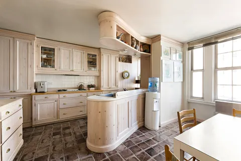 a kitchen with a stove a sink and a refrigerator