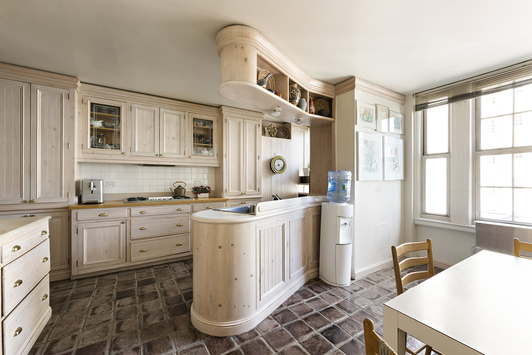 815 Park Avenue, Unit 8A Manhattan, NY 10021 - Photo 5 of 8 a kitchen with a stove a sink and a refrigerator