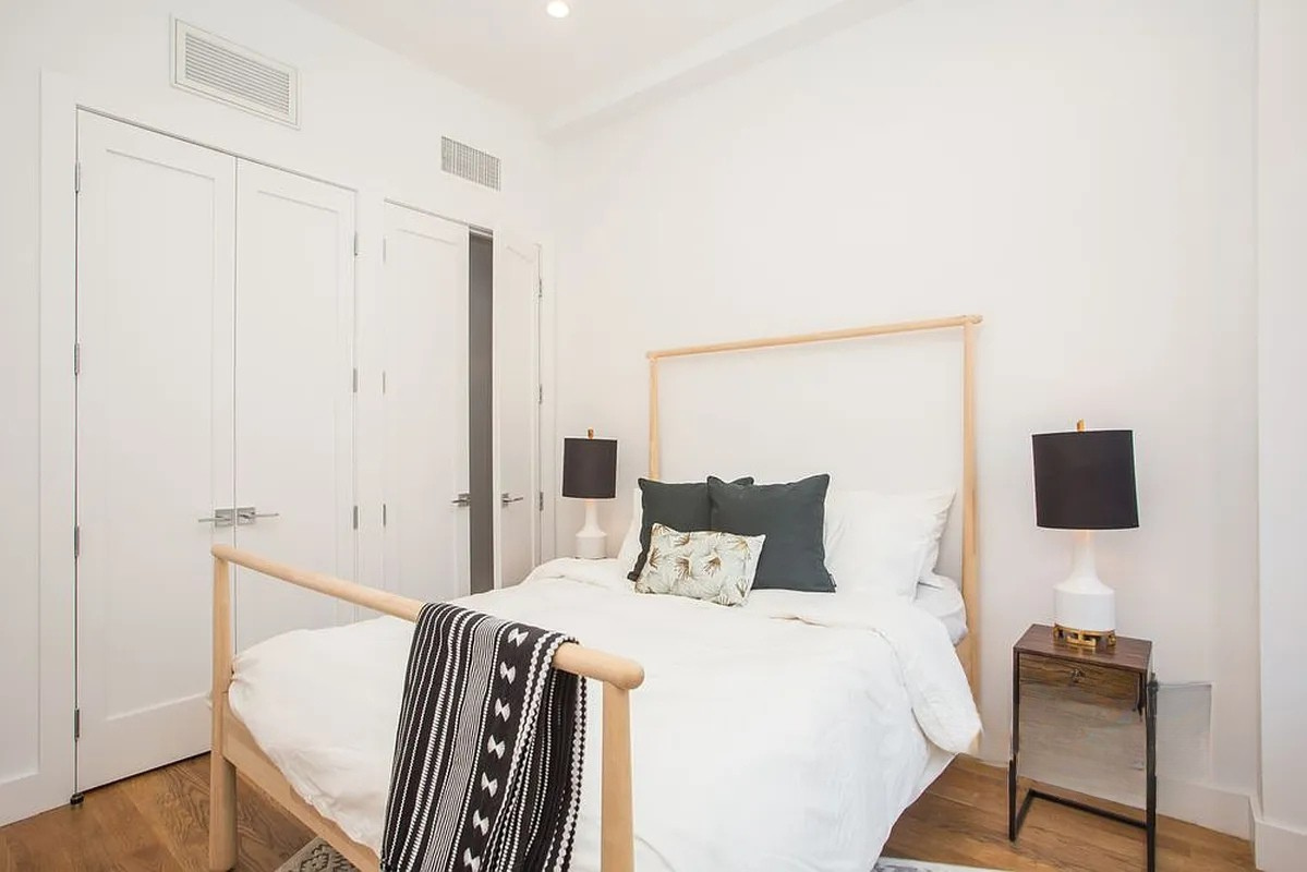 222 Withers Street, Unit 2A Brooklyn, NY 11211 - Photo 3 of 11 a bedroom with a bed and a chair in it