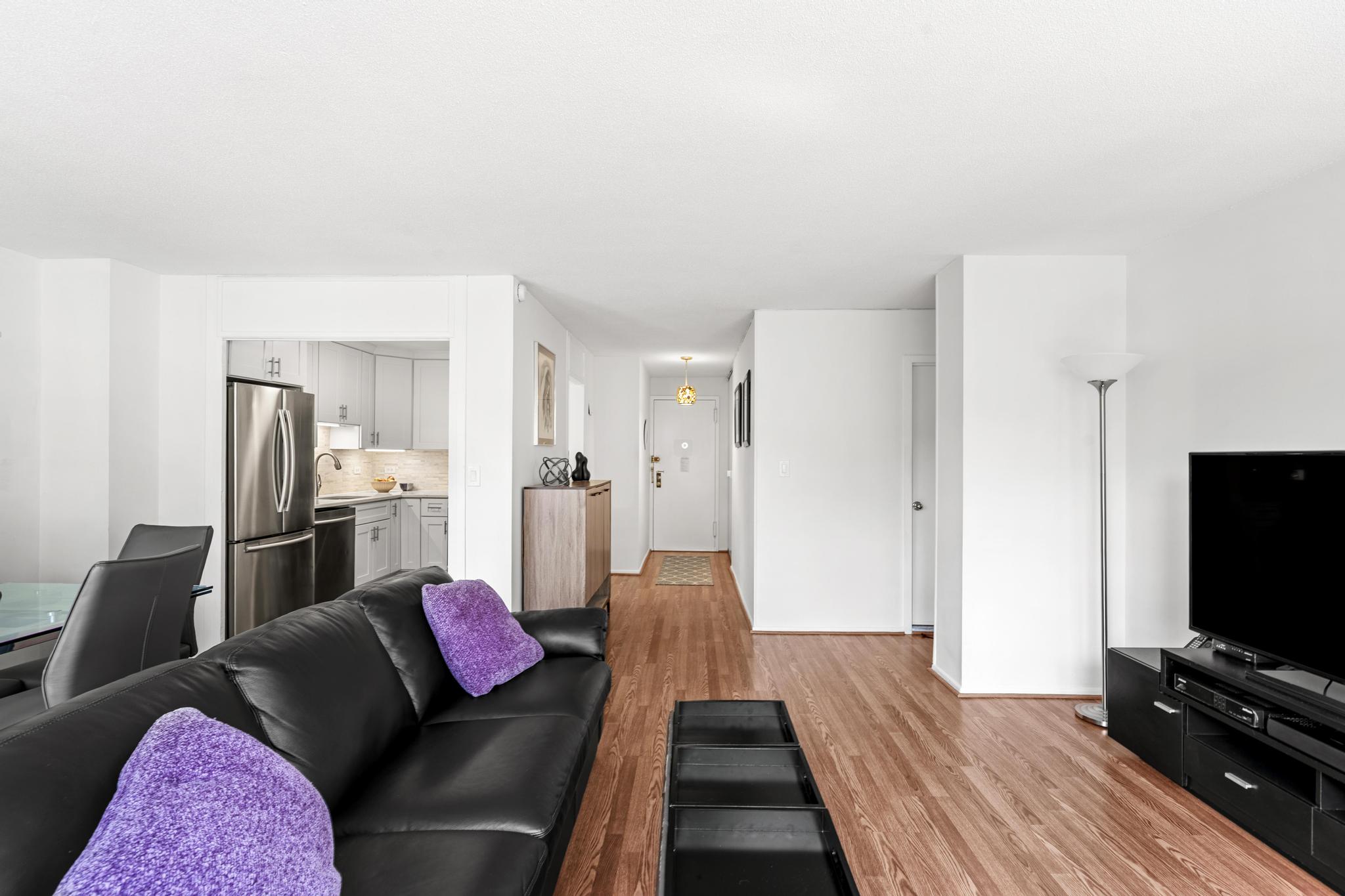 290 West 232nd Street, Unit 2C Bronx, NY 10463 - Photo 4 of 13 a living room with furniture and a flat screen tv