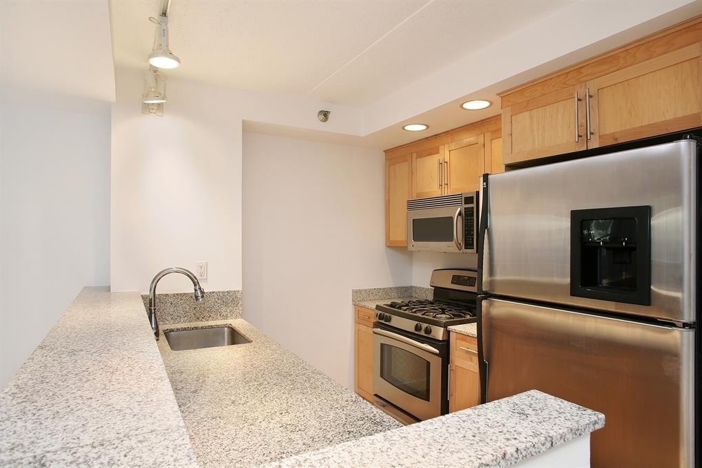 53 Boerum Place, Unit 2J Brooklyn, NY 11201 - Photo 2 of 9 a kitchen with stainless steel appliances granite countertop a sink stove and refrigerator