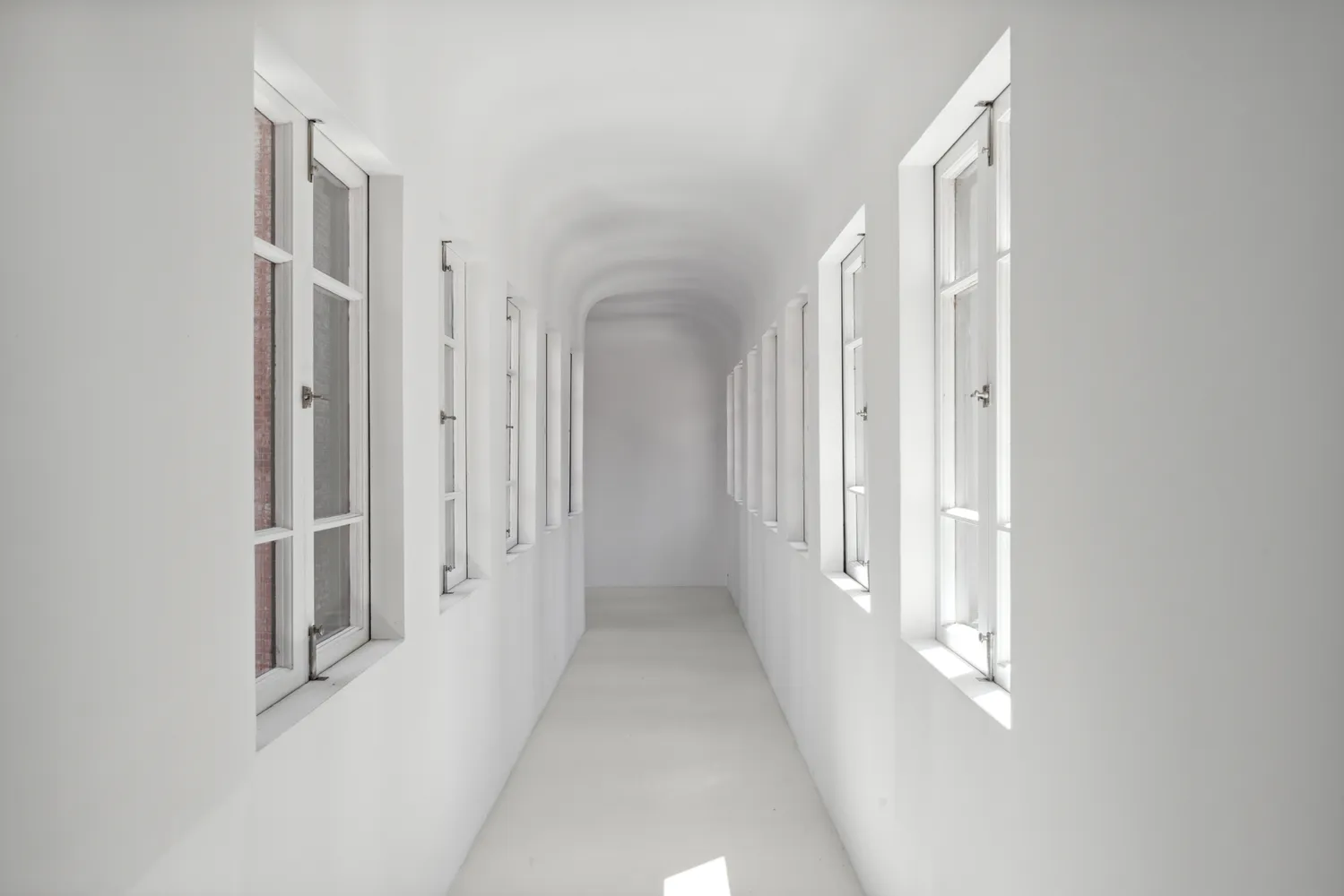 a view of a hallway with a white walls