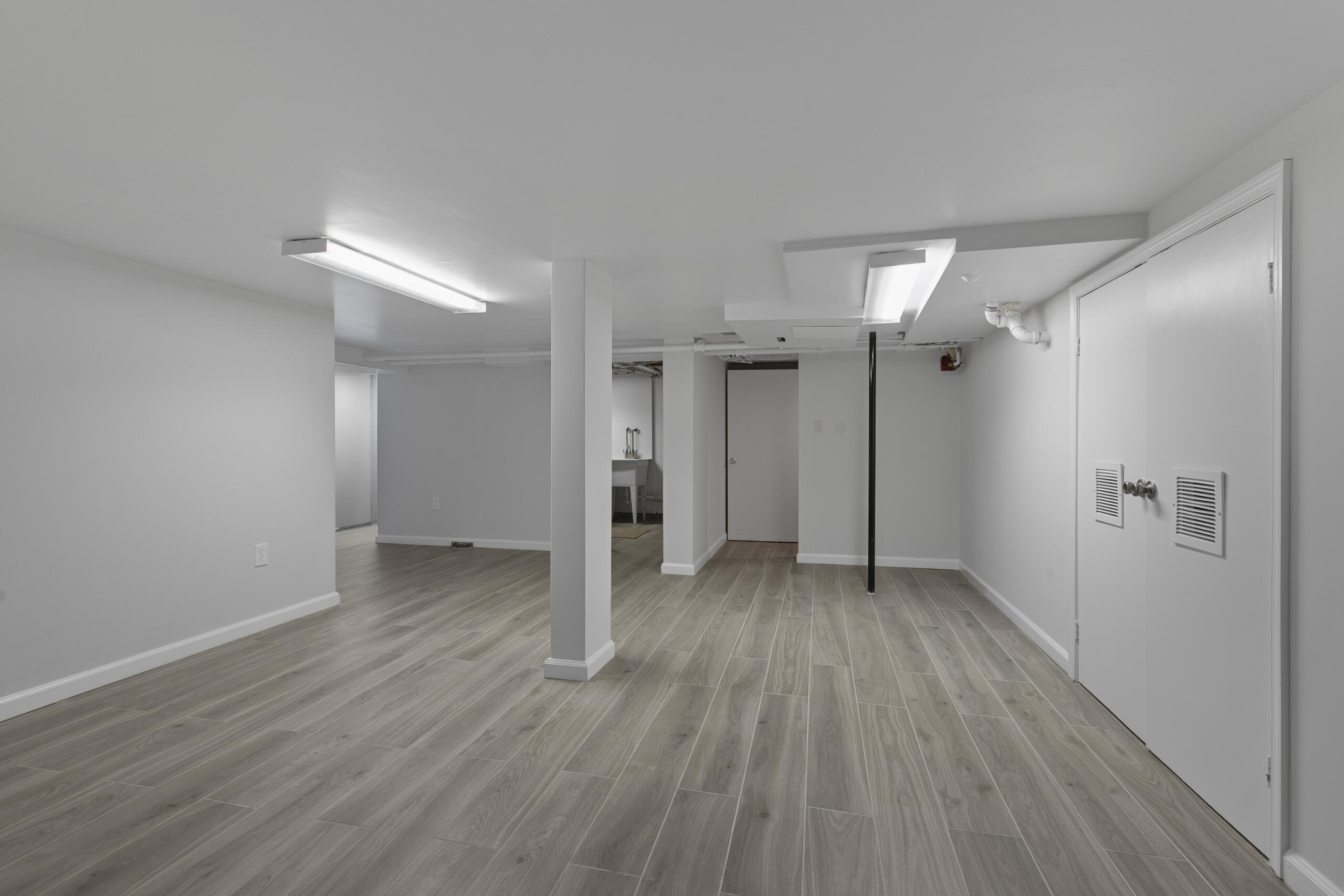1908 Glen Ross Road Silver Spring, MD 20910 - Photo 47 of 63 an empty room with wooden floor and a bathroom