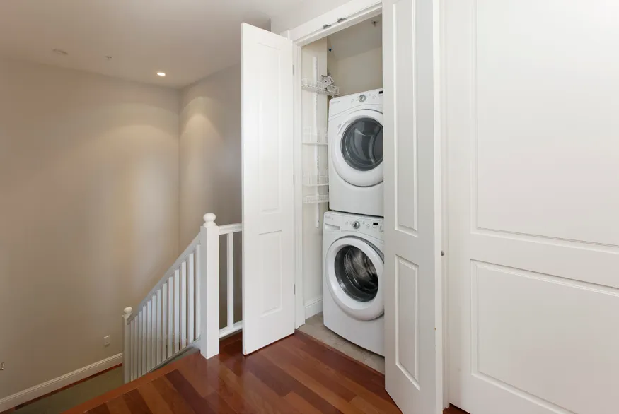 a view of a hallway with washer and dryer