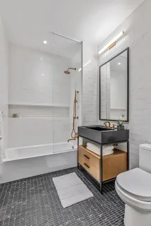 a bathroom with a toilet a sink and mirror