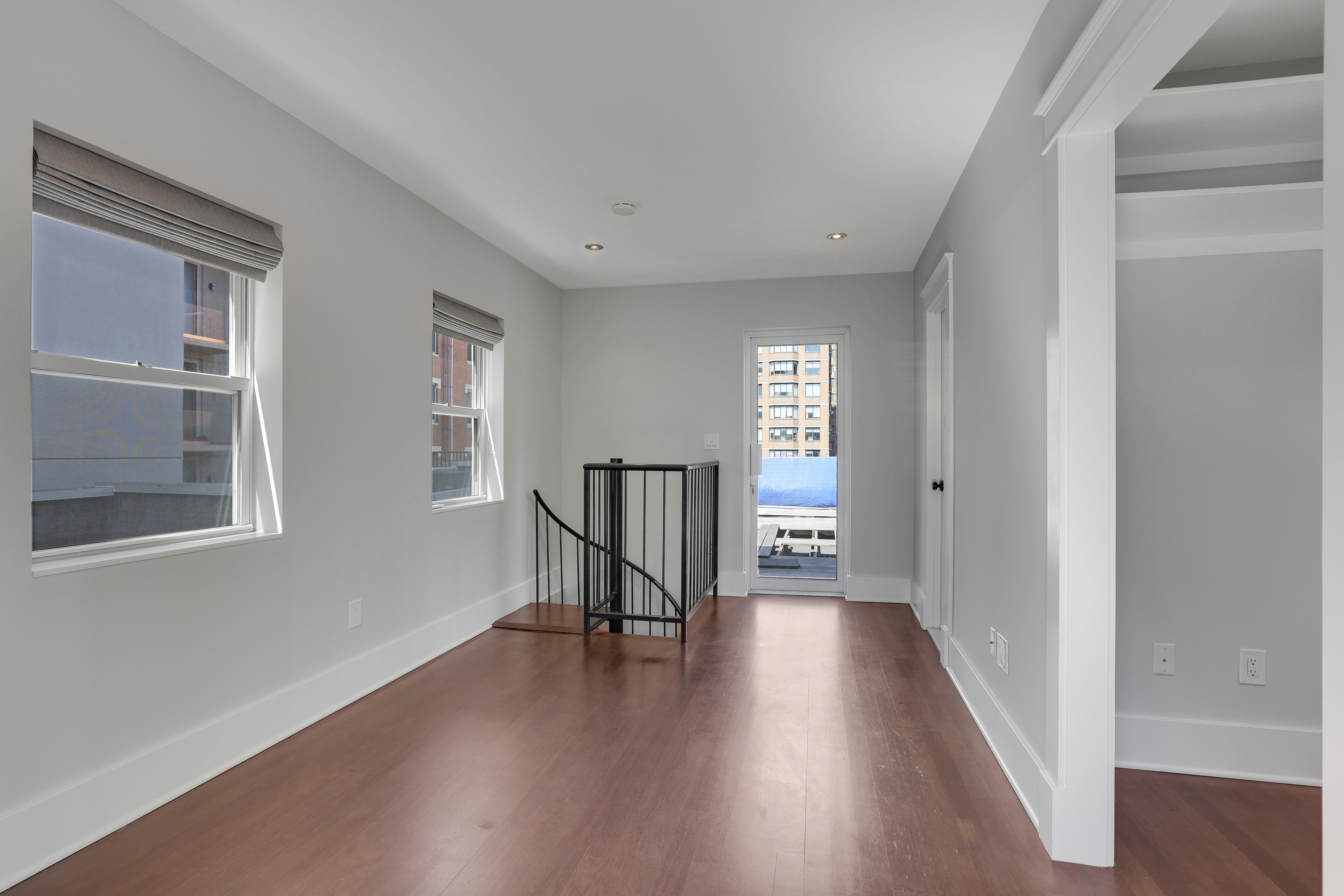 133 East 30th Street, Unit PH5B Manhattan, NY 10016 - Photo 20 of 24 a view of a hallway with wooden floor and a living room