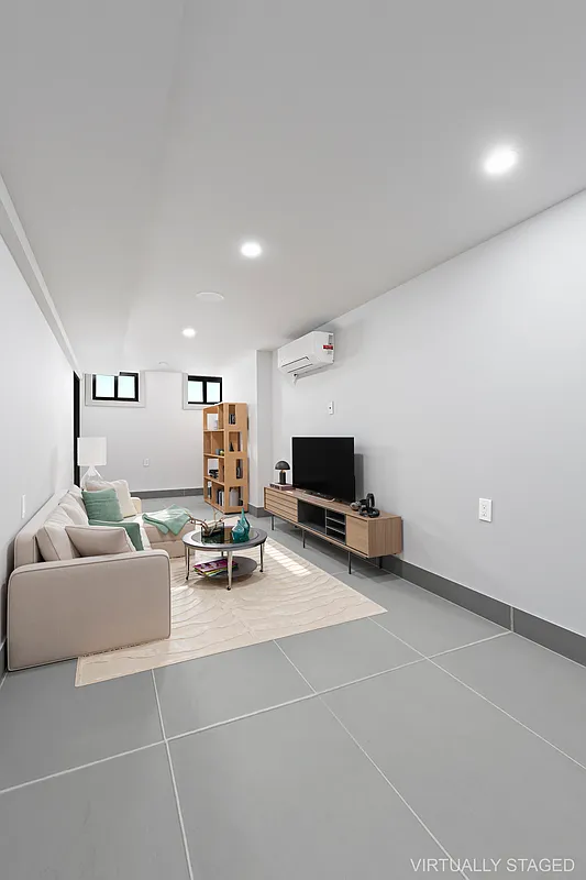 506 Woodward Avenue, Unit 1R Queens, NY 11385 - Photo 8 of 10 a living room with furniture and a flat screen tv