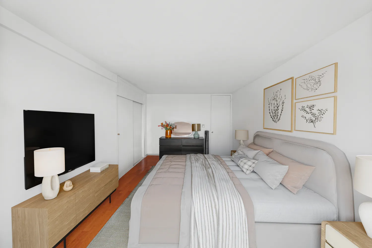 a bedroom with a bed and a painting on the wall