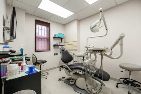 a work room with furniture and a flat screen tv
