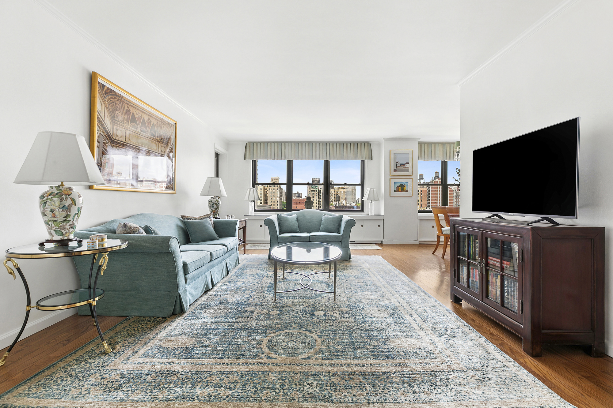 1199 Park Avenue, Unit 10K Manhattan, NY 10128 - Photo 1 of 12 a living room with furniture and a flat screen tv