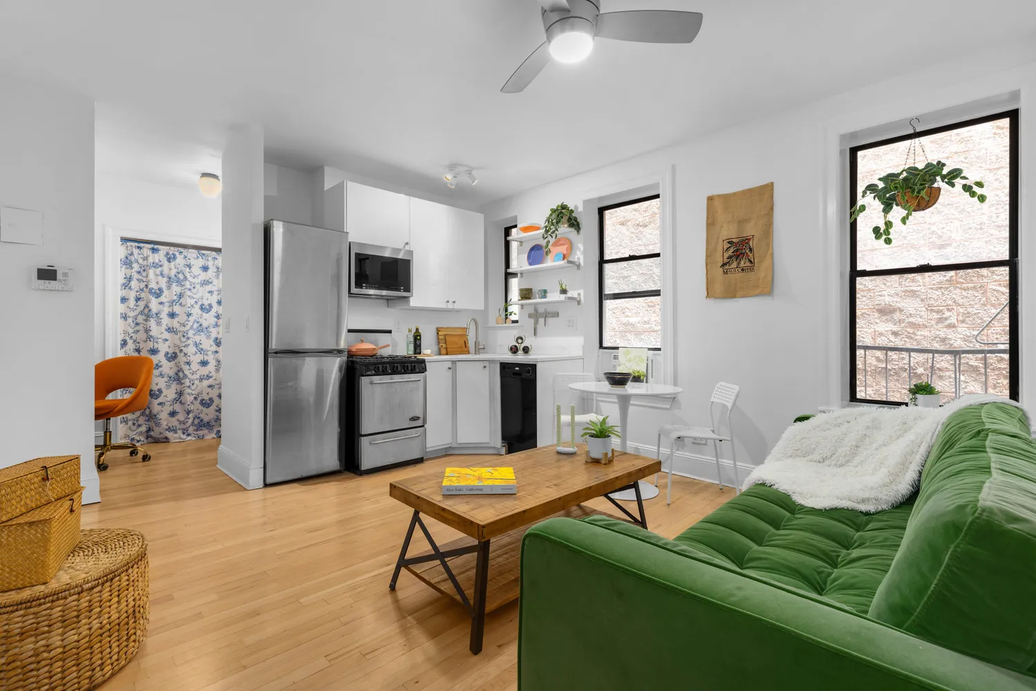 a living room with furniture a flat screen tv and a large window