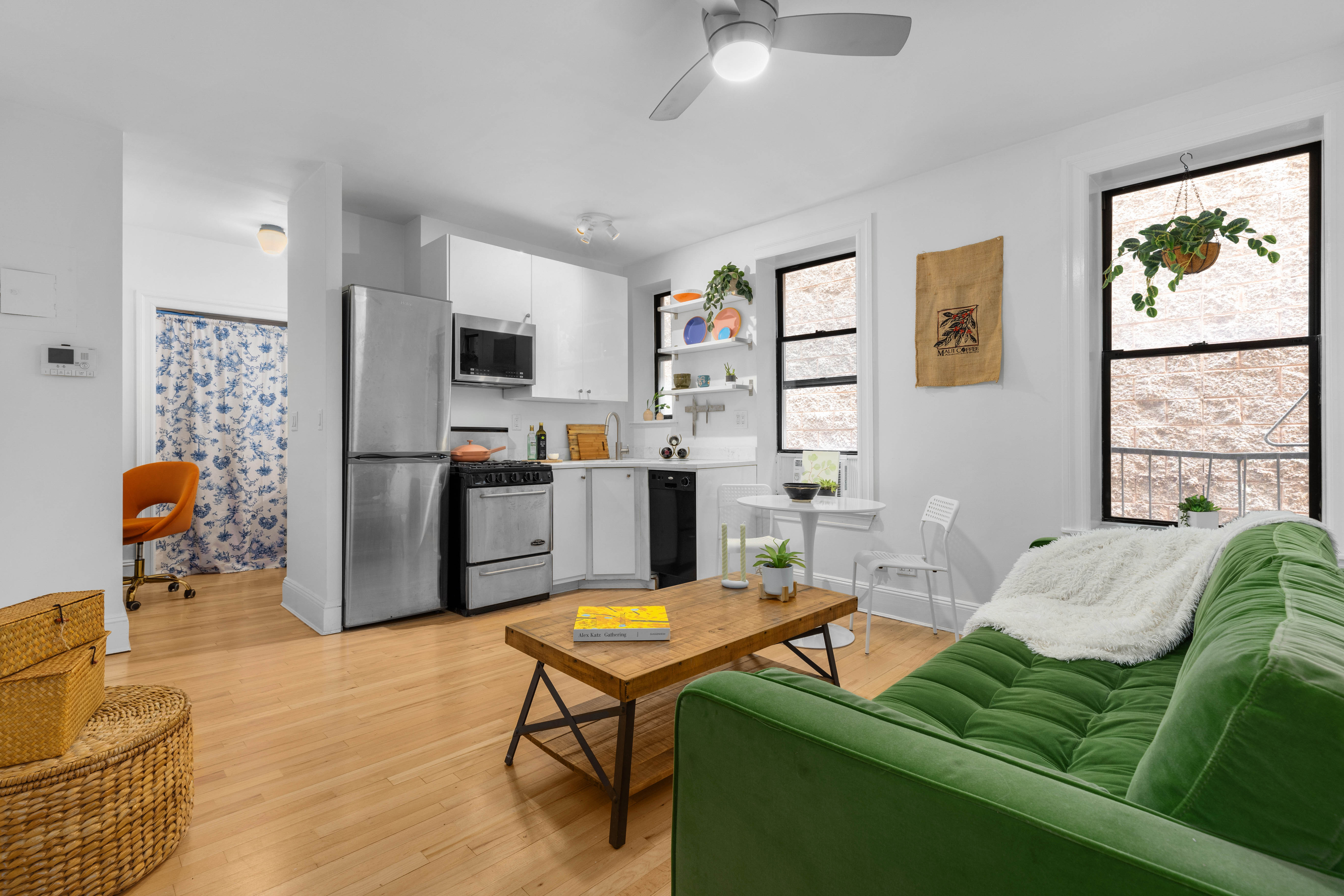 a living room with furniture a flat screen tv and a large window