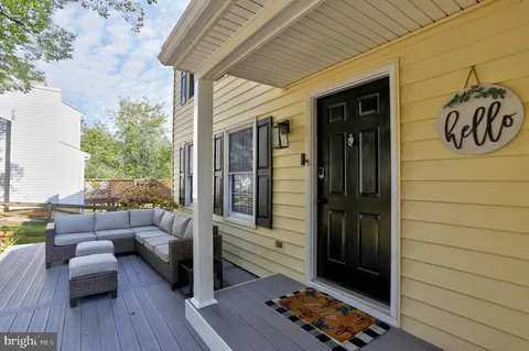 a view of a patio with couches chairs and a potted plant