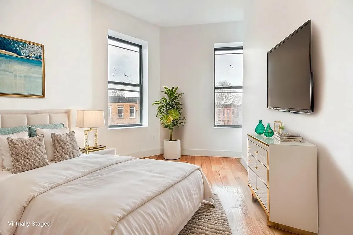 a bedroom with a bed and a flat screen tv