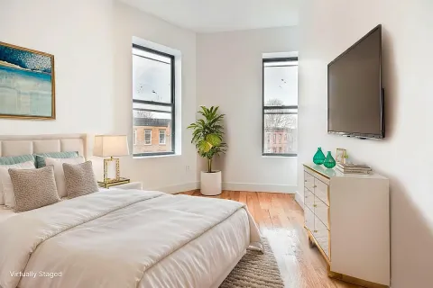 a bedroom with a bed and a flat screen tv