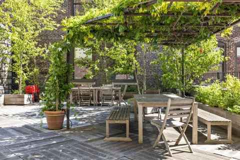 a view of a patio with table and chairs and potted plants