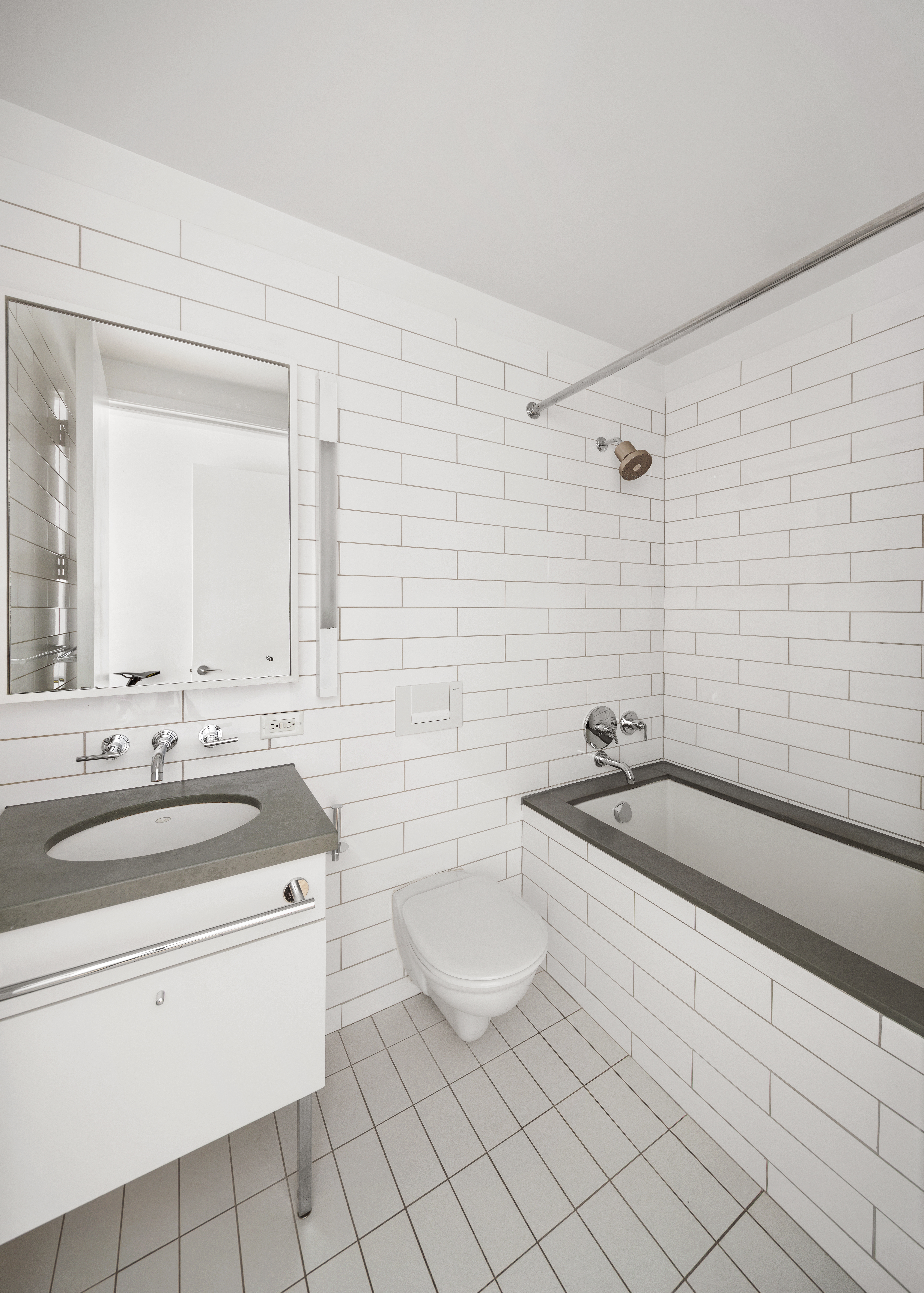 330 Spring Street, Unit 11B Manhattan, NY 10013 - Photo 9 of 10 a bathroom with a sink a toilet and mirror