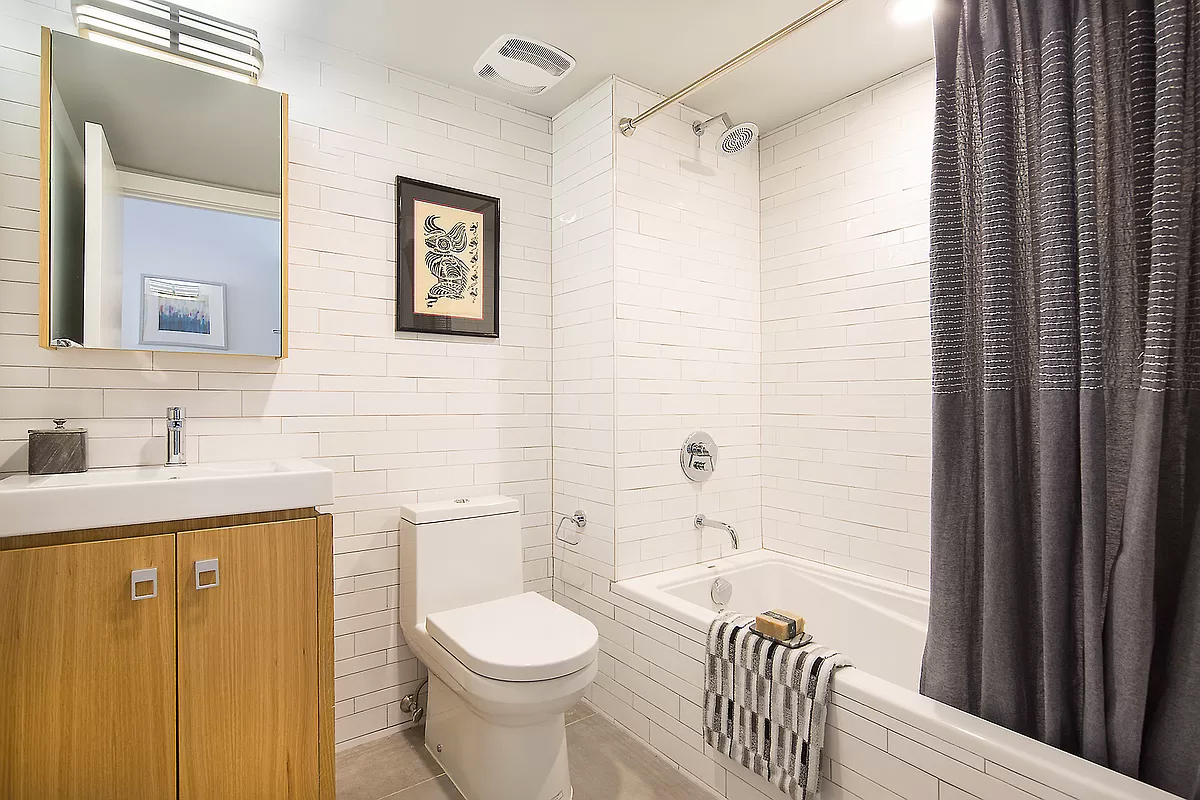 328 Central Avenue, Unit 3B Brooklyn, NY 11221 - Photo 8 of 11 a bathroom with a toilet a sink and bathtub