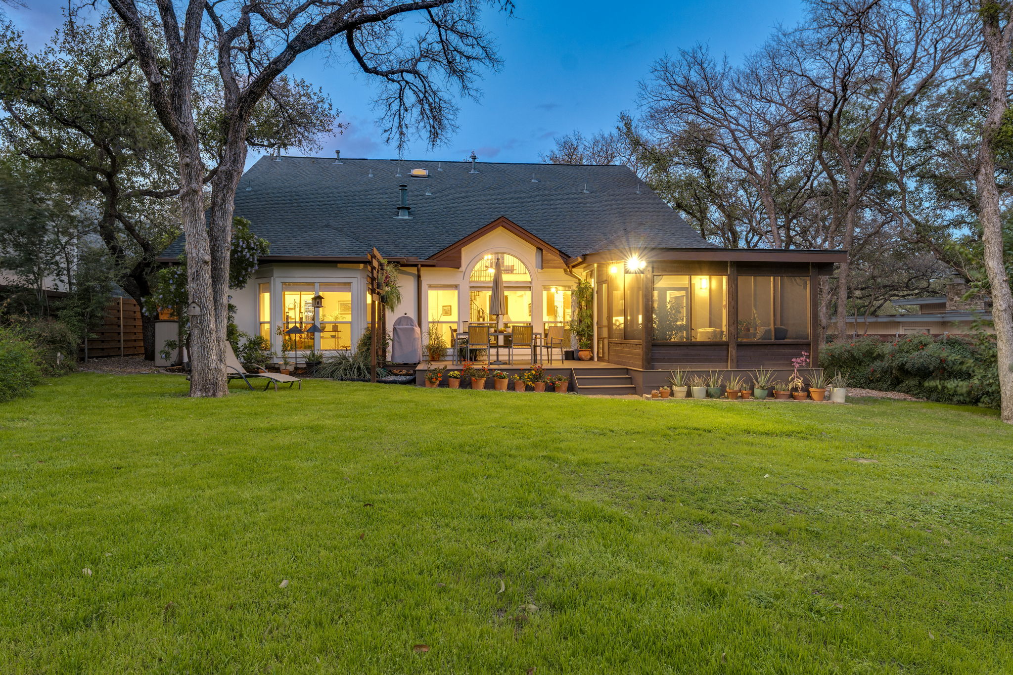 109 West Spring Drive Austin, TX 78746 - Photo 3 of 22 a view of a house next to a yard