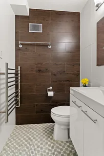 a bathroom with a toilet and a shower