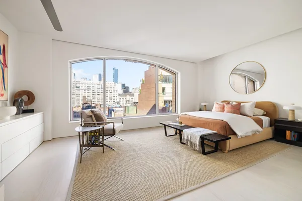 a spacious bedroom with a bed and a large window