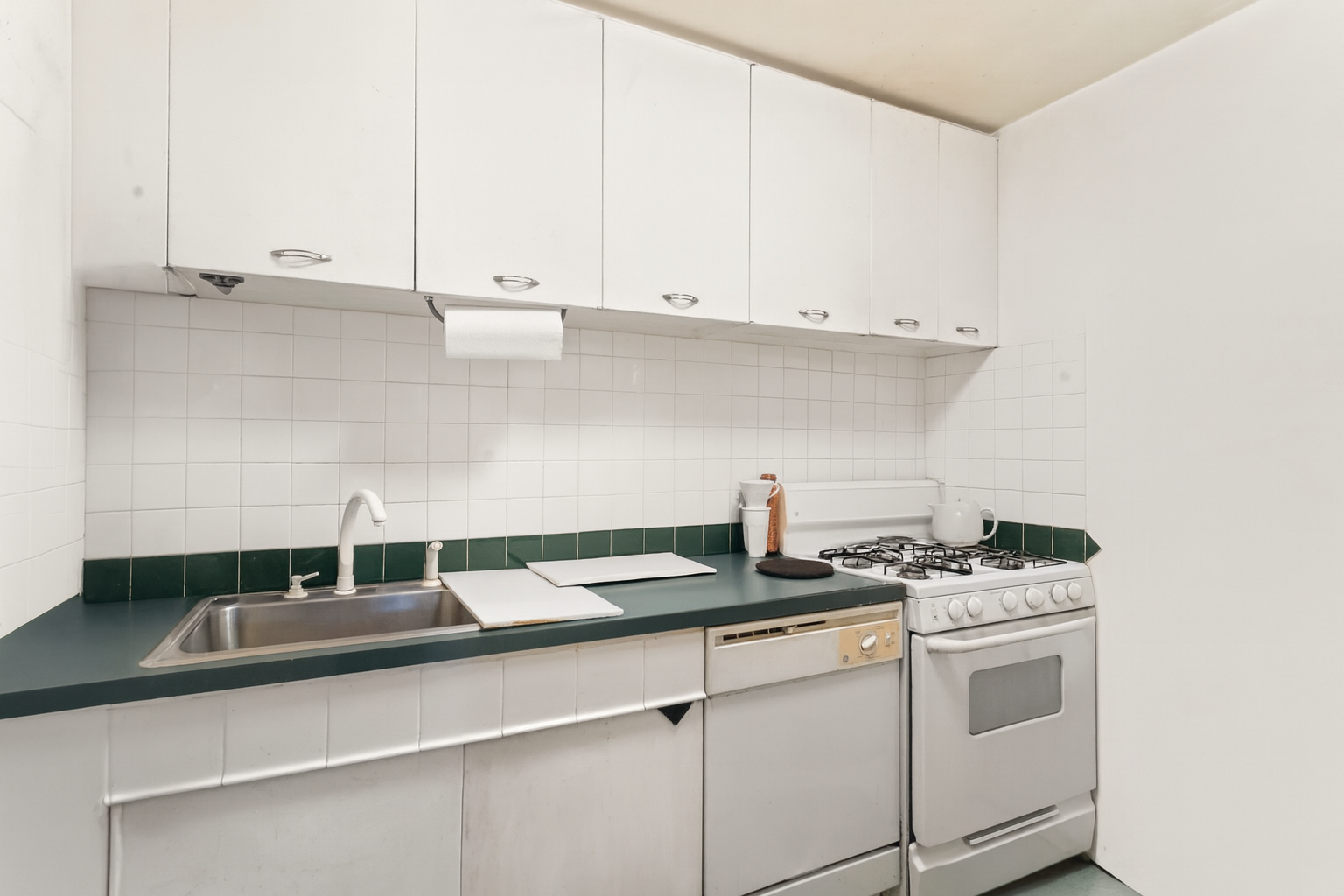 333 East 79th Street, Unit 7P Manhattan, NY 10075 - Photo 7 of 13 a kitchen with a sink and cabinets