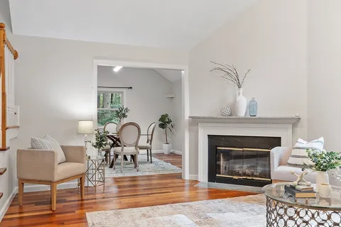 a living room with furniture a fireplace and a table