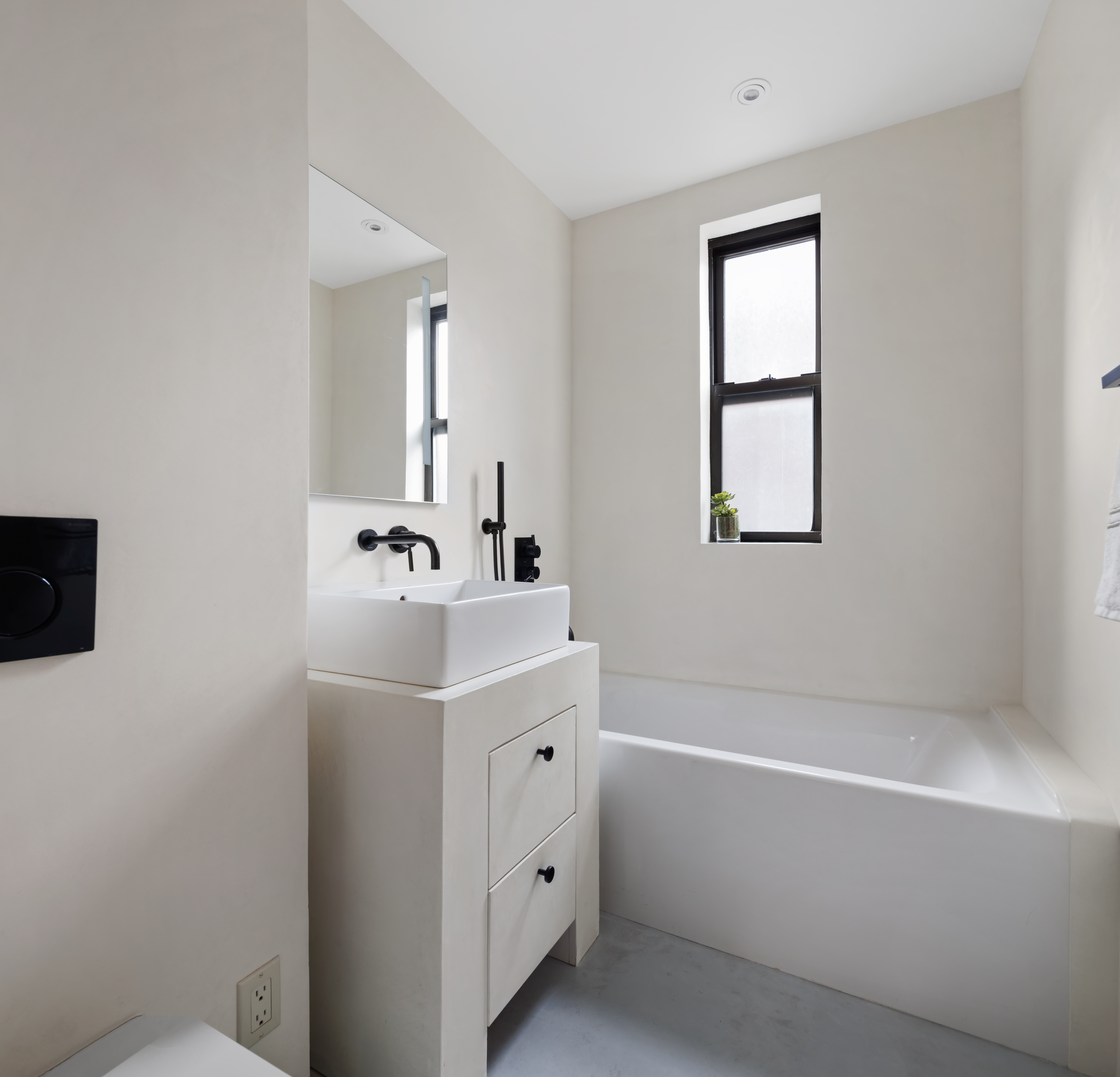 45 5th Avenue, Unit 15CD Manhattan, NY 10003 - Photo 11 of 14 a bathroom with a sink a mirror and a bathtub