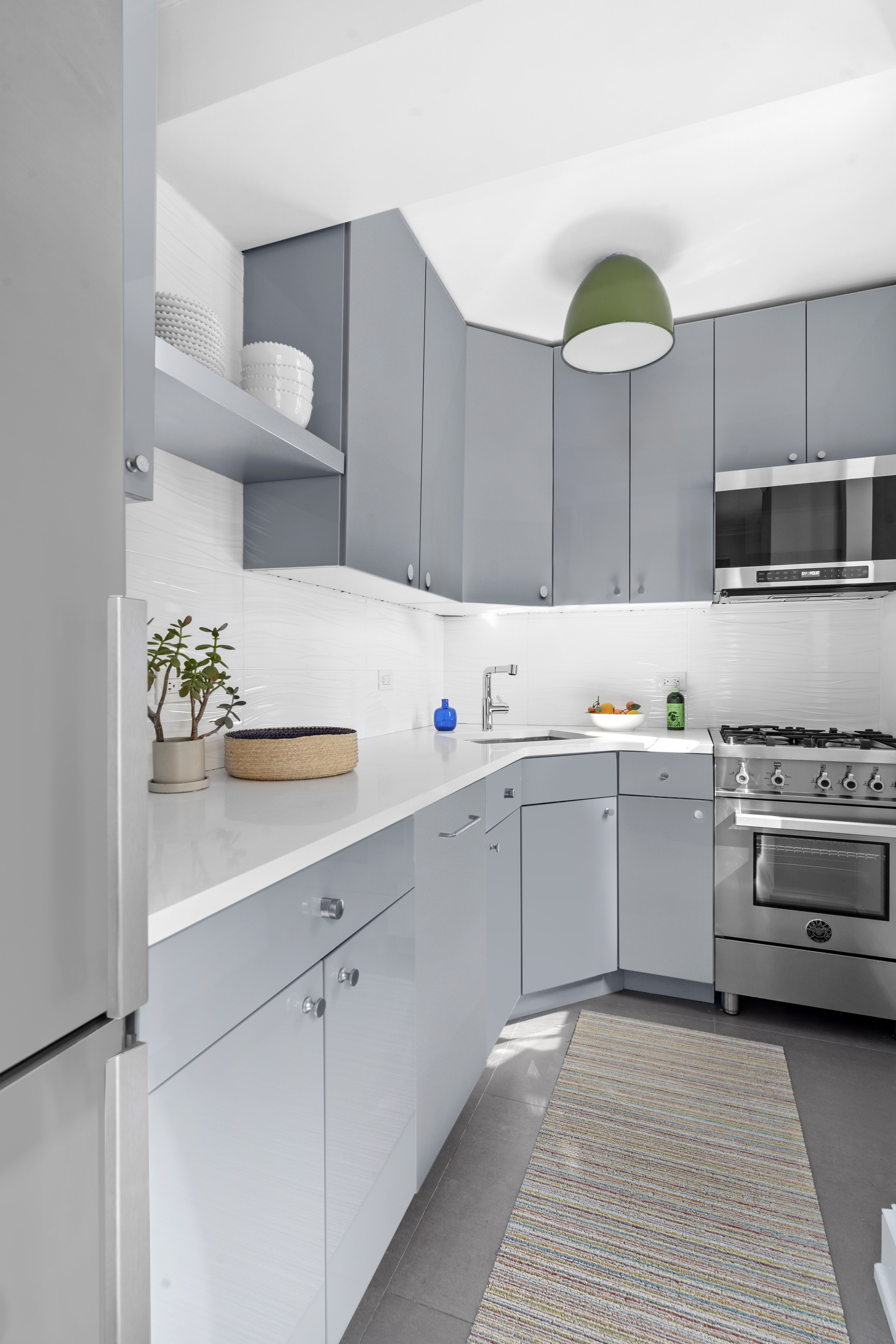 200 East 16th Street, Unit 5D Manhattan, NY 10003 - Photo 4 of 7 a kitchen with cabinets a sink and white stainless steel appliances