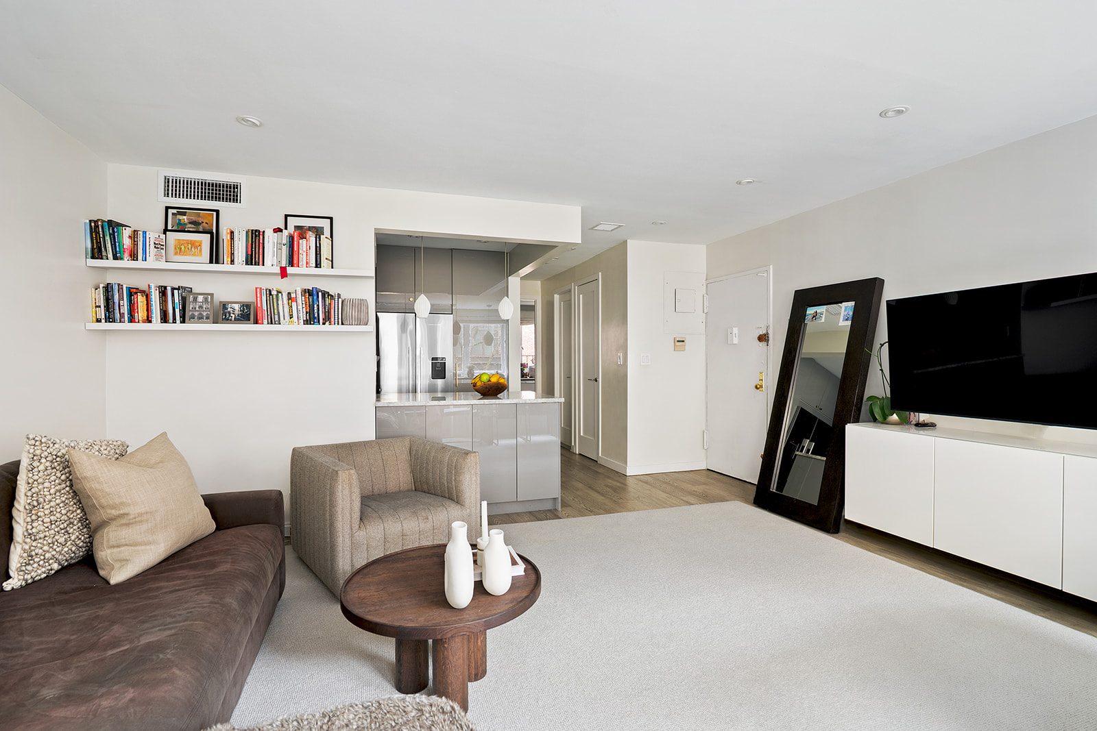 712 Washington Street, Unit 2A Manhattan, NY 10014 - Photo 4 of 8 a living room with furniture and a flat screen tv