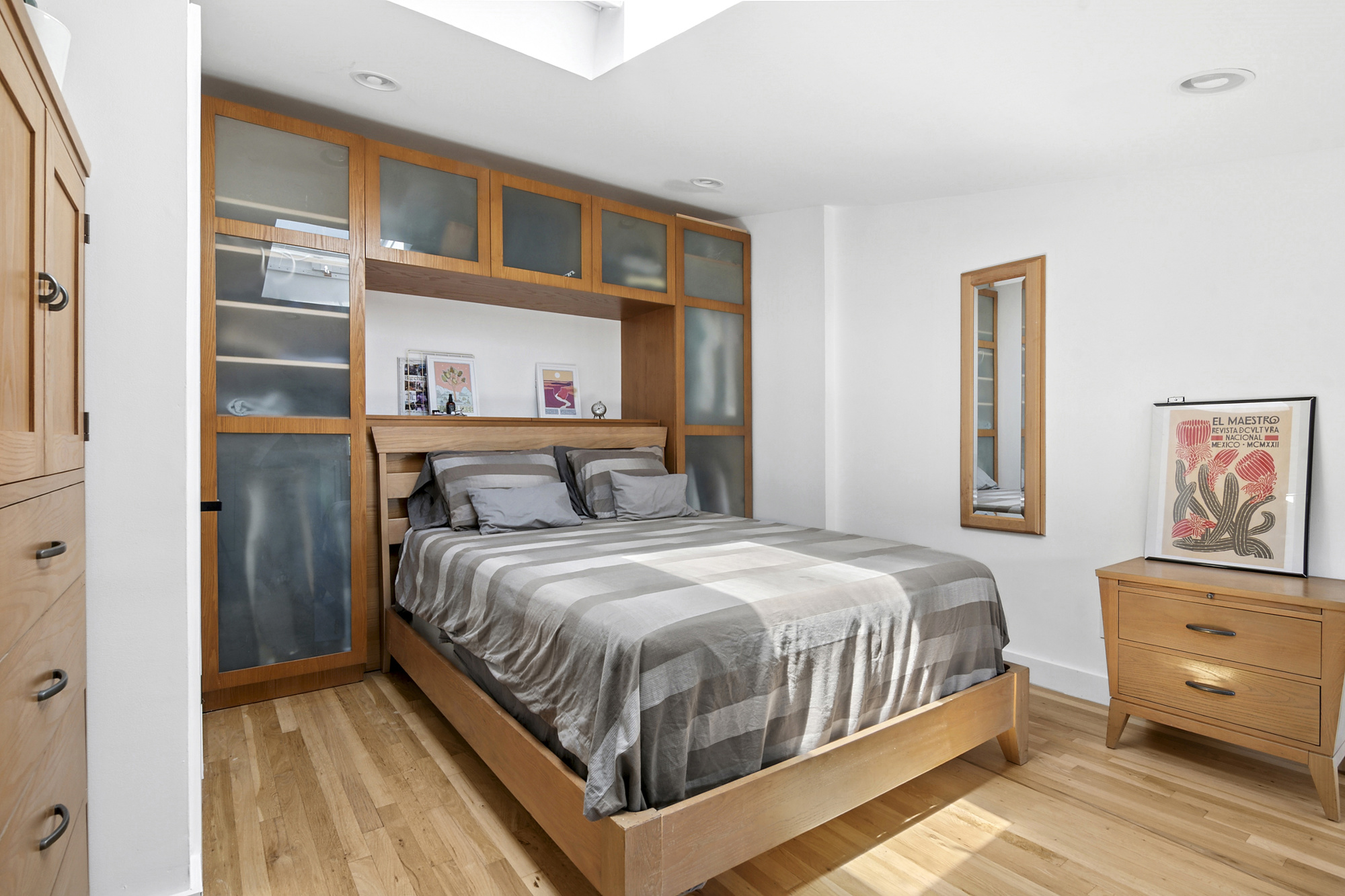 106 Battery Avenue, Unit 301 Brooklyn, NY 11209 - Photo 5 of 8 a bedroom with a bed and a cabinets