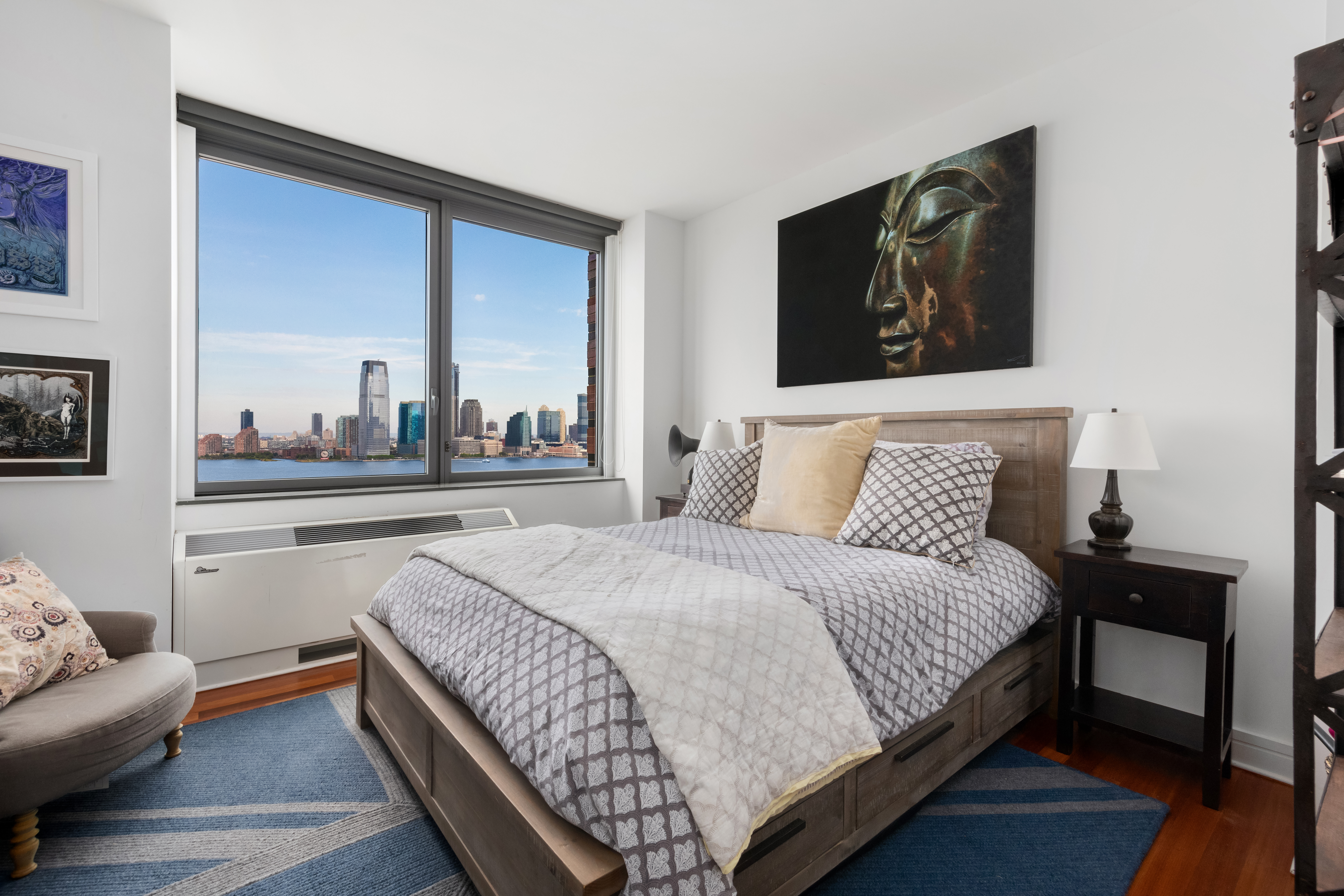 30 West Street, Unit 23F Manhattan, NY 10004 - Photo 5 of 12 a bedroom with a bed and window