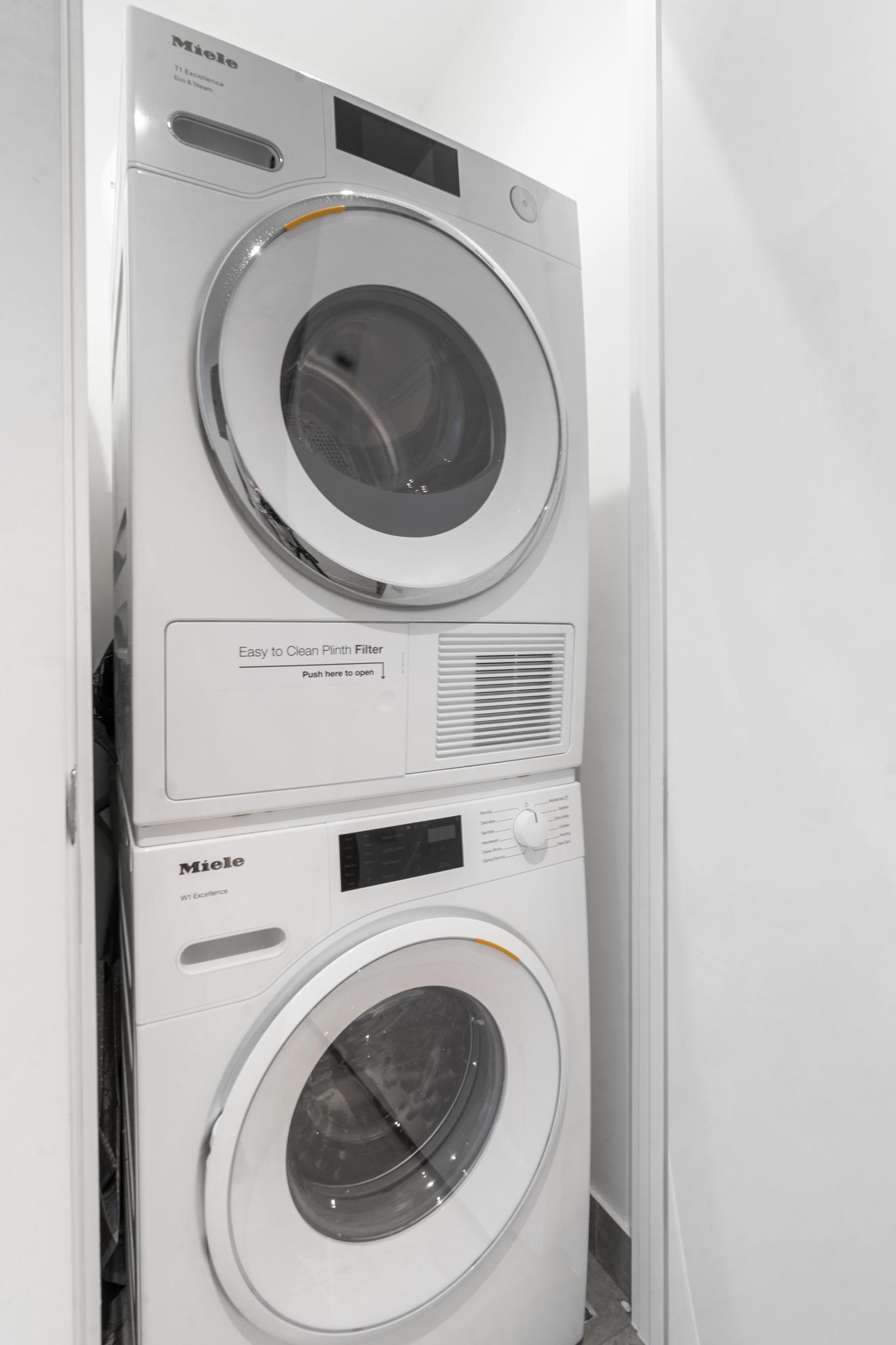 208 Delancey Street, Unit GC Manhattan, NY 10002 - Photo 7 of 12 a utility room with dryer and washer