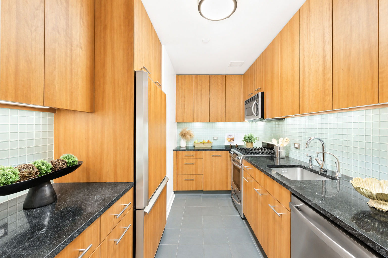 11 East 29th Street, Unit 34B Manhattan, NY 10016 - Photo 4 of 10 a kitchen with stainless steel appliances granite countertop a sink a stove and a refrigerator
