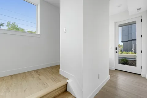 a view of an entryway and wooden floor