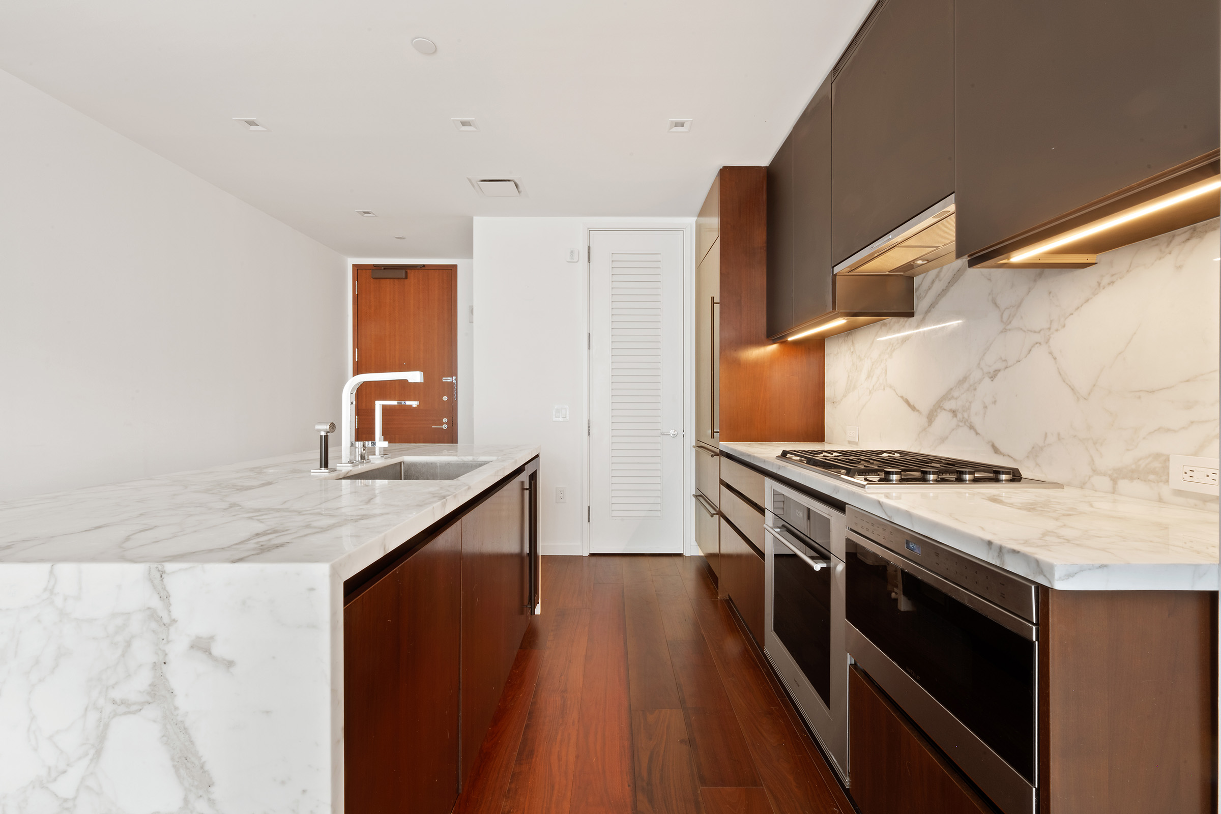 1 West End Avenue, Unit 14G Manhattan, NY 10023 - Photo 3 of 27 a kitchen with stainless steel appliances granite countertop a stove and a sink